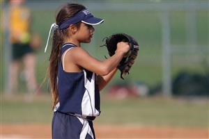 Young softball player preparing to pitch.
